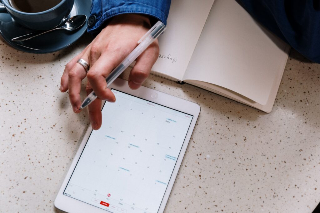 Perfect Timing: The Art of Strategically Releasing Your Press Release for Maximum Media Attention 6 A person looking at a digital tablet planning their media attention