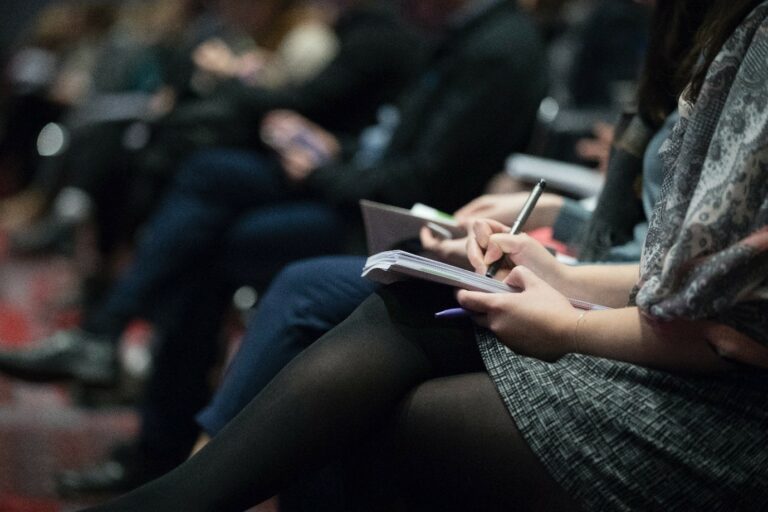 An Image of a person writing in their notebook. A Pro Write