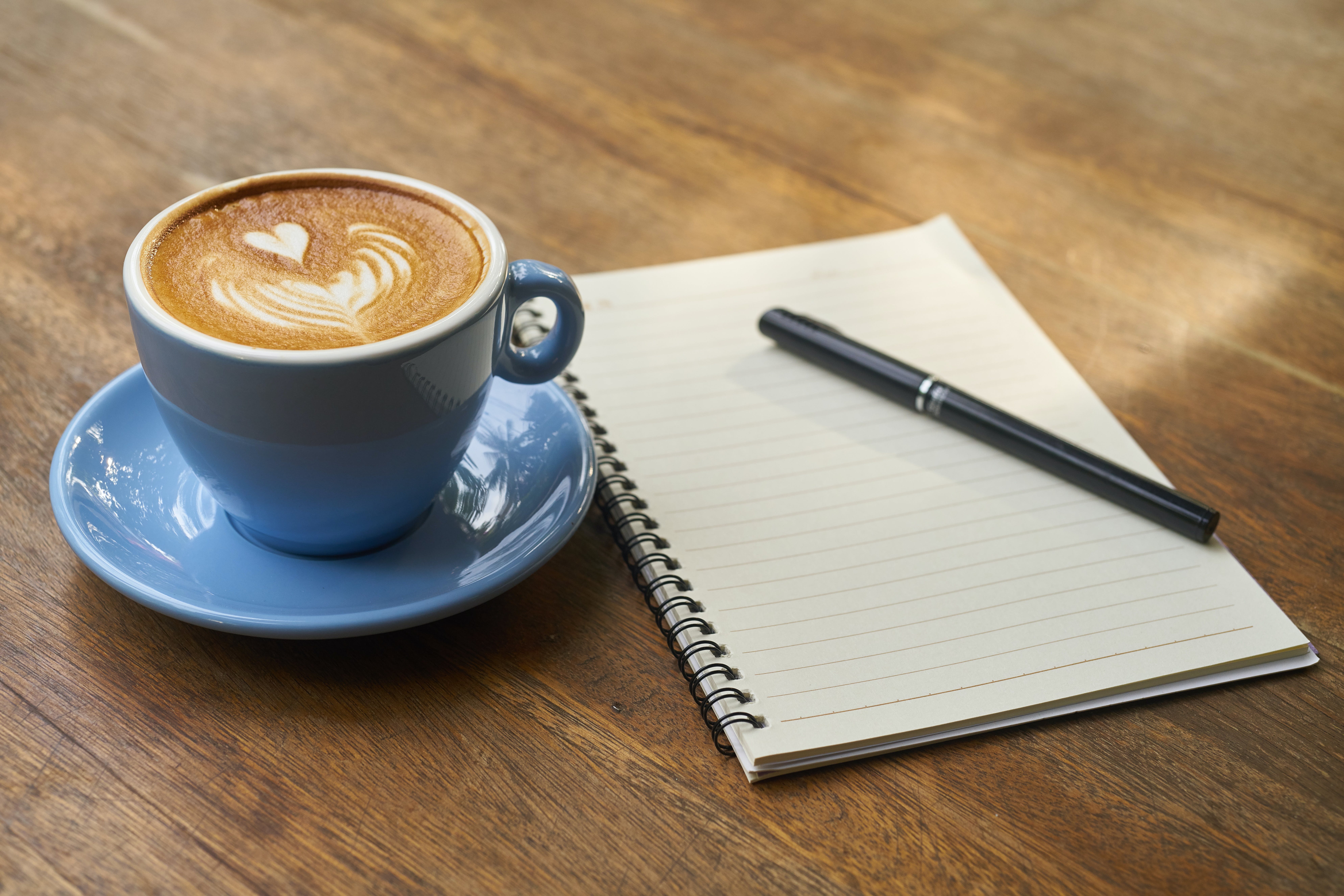 What are the 5 W's to Cover in the Press Release Opening Paragraph 1 An image of a notebook with a pen on the top with a coffee next to it