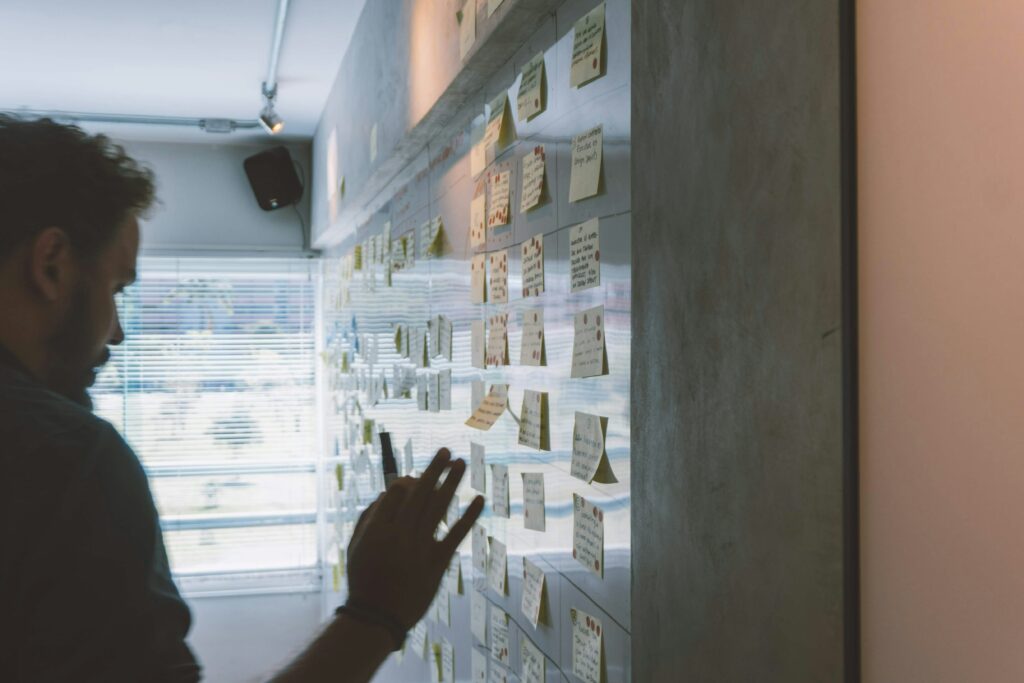 A person staring at a whiteboard planning their start-up campaign