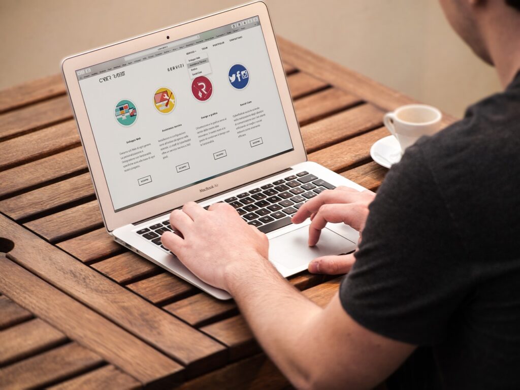 A person, looking at their computer searching for a press release, blog or news