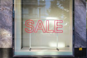 A window displaying a bright sale sign, inviting customers to explore the black friday offers inside.