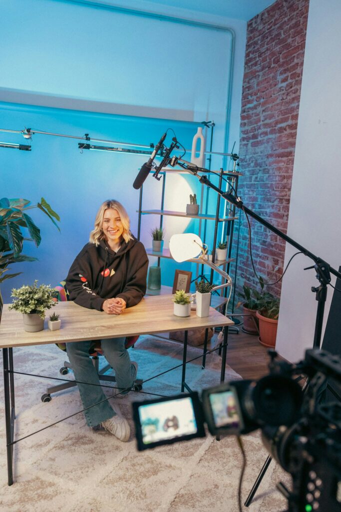 Insights Page | a person sat at a desk talking into a digital camera